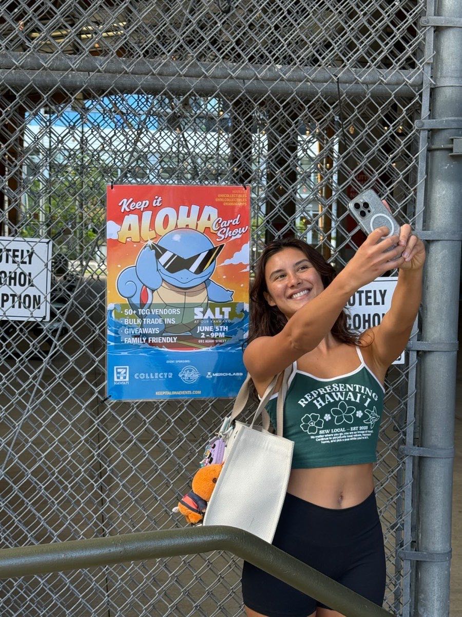Attendee by the Keep It Aloha Card Show poster (sponsored by Collectr) at SALT Kaka'ako