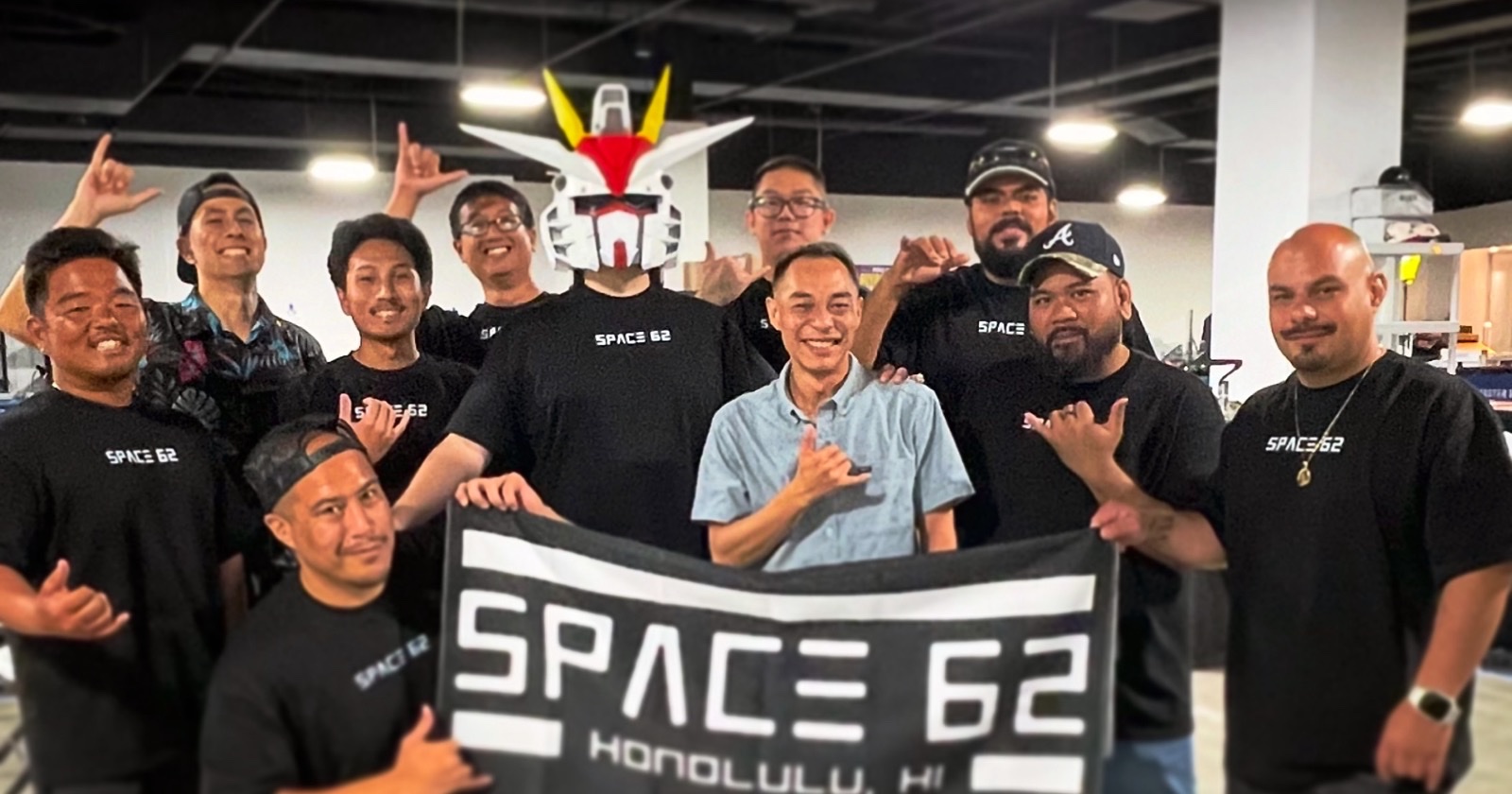 The Space 62 team holding the Space 62 Honolulu banner at their first Collectibles Show, Ala Moana Center, June 2026